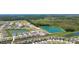 Aerial view of a Primary-planned community featuring ponds, green spaces, and modern homes at 31440 Barrel Wave Way, Wesley Chapel, FL 33545