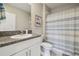 Bathroom featuring granite counters, white cabinets, and a shower/tub with a curtain at 31440 Barrel Wave Way, Wesley Chapel, FL 33545