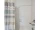 Bathroom shower/tub featuring white subway tile and a blue, grey, and white striped shower curtain at 31440 Barrel Wave Way, Wesley Chapel, FL 33545