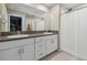 Bathroom featuring dual sinks, granite countertop, white cabinetry, and shower with curtain at 31440 Barrel Wave Way, Wesley Chapel, FL 33545