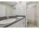 Bathroom features double sinks with granite countertops, and access to a full bath at 31440 Barrel Wave Way, Wesley Chapel, FL 33545