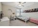 Bedroom featuring a ceiling fan and posters displayed on the wall above a white twin-sized bed at 31440 Barrel Wave Way, Wesley Chapel, FL 33545