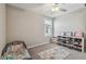 Bright bedroom with a small bed, a ceiling fan, and gray carpet throughout at 31440 Barrel Wave Way, Wesley Chapel, FL 33545