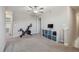 Upstairs bonus room with carpeted floors, a ceiling fan, and a stationary bike at 31440 Barrel Wave Way, Wesley Chapel, FL 33545