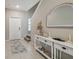 Welcoming foyer with stylish console table, decorative mirror, and neutral color palette at 31440 Barrel Wave Way, Wesley Chapel, FL 33545