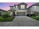 Charming two-story home with a well-manicured lawn and a two-car garage at 31440 Barrel Wave Way, Wesley Chapel, FL 33545