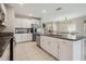 Bright kitchen with stainless steel appliances, granite countertops, and ample cabinet space at 31440 Barrel Wave Way, Wesley Chapel, FL 33545