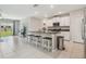 Open kitchen with an island, counter seating, and a view to the living area at 31440 Barrel Wave Way, Wesley Chapel, FL 33545