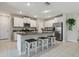 Well-equipped kitchen island with granite countertops, stainless steel appliances and seating at 31440 Barrel Wave Way, Wesley Chapel, FL 33545
