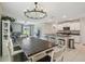 Open-concept kitchen and dining area with modern lighting and stainless steel appliances at 31440 Barrel Wave Way, Wesley Chapel, FL 33545