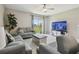 Inviting living room featuring tile flooring, neutral paint, and sliding glass doors leading to backyard at 31440 Barrel Wave Way, Wesley Chapel, FL 33545