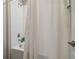 Bright white shower featuring subway tile surround and chrome shower head at 31440 Barrel Wave Way, Wesley Chapel, FL 33545