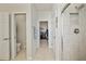 Bright bathroom featuring tile floors, a glass-enclosed shower, and access to a walk-in closet at 3159 Marisa Pl, Holiday, FL 34691