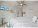 Spacious bedroom featuring neutral walls, a ceiling fan, and a wall-mounted TV at 3159 Marisa Pl, Holiday, FL 34691