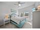 Bright bedroom with a ceiling fan, two windows, and a comfortable blue bed at 3159 Marisa Pl, Holiday, FL 34691