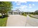 Attractive home featuring a spacious driveway, three-car garage, and well-maintained front yard at 3159 Marisa Pl, Holiday, FL 34691