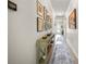 Well-lit hallway with console table and rug, showcasing the home's spacious layout and decor at 3159 Marisa Pl, Holiday, FL 34691