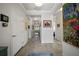 Bright hallway featuring tiled floors, neutral paint, and stylish decorative artwork on the walls at 3159 Marisa Pl, Holiday, FL 34691