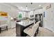 Well-lit kitchen featuring a black island, white cabinets, and stainless steel appliances at 3159 Marisa Pl, Holiday, FL 34691