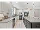 Bright kitchen with a black island, white cabinets, and stainless steel appliances at 3159 Marisa Pl, Holiday, FL 34691