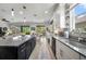 Bright, modern kitchen with granite countertops, stainless appliances, and a view to the backyard at 3159 Marisa Pl, Holiday, FL 34691