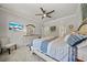 Spacious main bedroom with a ceiling fan, dresser, and an ensuite bathroom at 3159 Marisa Pl, Holiday, FL 34691