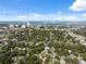 Scenic aerial view captures the neighborhood with lush trees and a distant cityscape across the sparkling waterfront at 317 N Washington Ave, Clearwater, FL 33755