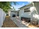 Back patio with pavers, grill, and sliding glass door leading inside, offering a great space for outdoor cooking and relaxation at 317 N Washington Ave, Clearwater, FL 33755
