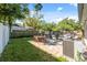 Spacious backyard featuring a stone patio with dining and lounge seating, perfect for entertaining or relaxing outdoors at 317 N Washington Ave, Clearwater, FL 33755