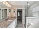 Bright bathroom featuring a granite vanity and a frameless glass shower, providing a modern look at 317 N Washington Ave, Clearwater, FL 33755