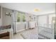 Stylish Bedroom room with ample natural light, a crib, and a changing table for the baby at 317 N Washington Ave, Clearwater, FL 33755
