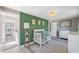 Stylish Bedroom room boasting a green accent wall, a crib, and a changing table for the baby at 317 N Washington Ave, Clearwater, FL 33755