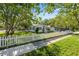 Inviting single-story home with a white picket fence and beautiful mature shade trees at 317 N Washington Ave, Clearwater, FL 33755