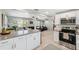 Open concept kitchen with stainless steel appliances, granite counters, and connection to living spaces at 317 N Washington Ave, Clearwater, FL 33755