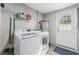Functional laundry room equipped with a washer, dryer, and storage, making chores convenient at 317 N Washington Ave, Clearwater, FL 33755