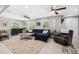 Spacious living room featuring a plush sofa, ceiling fans, and large windows for ample natural light at 317 N Washington Ave, Clearwater, FL 33755