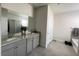 Bright bathroom featuring a double sink vanity with granite countertops and a large mirror at 33034 Sand Creek Dr, Wesley Chapel, FL 33543