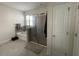 Bathroom featuring tile floors, a soaking tub, and glass enclosed shower at 33034 Sand Creek Dr, Wesley Chapel, FL 33543