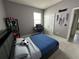 Bedroom features a desk and bed with sleek dark gray walls and carpeted floor at 33034 Sand Creek Dr, Wesley Chapel, FL 33543