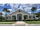 Beautiful clubhouse exterior surrounded by lush landscaping, perfect for community gatherings and events at 33034 Sand Creek Dr, Wesley Chapel, FL 33543