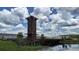 The community landmark surrounded by a pond, adds beauty and enhances the neighborhood's aesthetic appeal at 33034 Sand Creek Dr, Wesley Chapel, FL 33543
