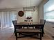 Bright dining room with a wooden table, upholstered bench, and stylish light fixture at 33034 Sand Creek Dr, Wesley Chapel, FL 33543