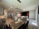Dining room with stylish pendant lighting and table connects kitchen and living spaces at 33034 Sand Creek Dr, Wesley Chapel, FL 33543