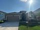 Inviting single-story home with well-maintained landscaping, a two-car garage, and a sunny curb appeal at 33034 Sand Creek Dr, Wesley Chapel, FL 33543