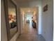 Hallway with neutral tile flooring connects to the main living area and features decorative shelving at 33034 Sand Creek Dr, Wesley Chapel, FL 33543