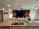 Spacious eat-in kitchen with granite countertops and island seating overlooks living area at 33034 Sand Creek Dr, Wesley Chapel, FL 33543