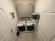 Functional laundry room featuring a washer, dryer, overhead cabinets, and ample storage space at 33034 Sand Creek Dr, Wesley Chapel, FL 33543