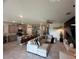 Open-concept living space with kitchen island, sectional sofa, and modern decor at 33034 Sand Creek Dr, Wesley Chapel, FL 33543