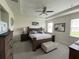 Main bedroom with tray ceilings, ceiling fan, and rustic wooden furniture at 33034 Sand Creek Dr, Wesley Chapel, FL 33543