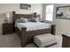 Bedroom features rustic wood furniture, tray ceiling, and carpeted floor at 33034 Sand Creek Dr, Wesley Chapel, FL 33543
